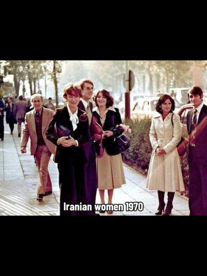 Iranian women and men walking on a Tehran street in 1970 in Western dress — skirts, blazers, hair visible. No headscarves.