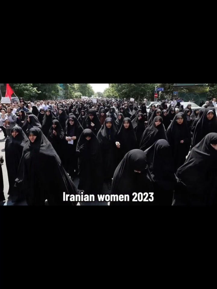 A large crowd of Iranian women marching in all-black chadors in 2023 Tehran.