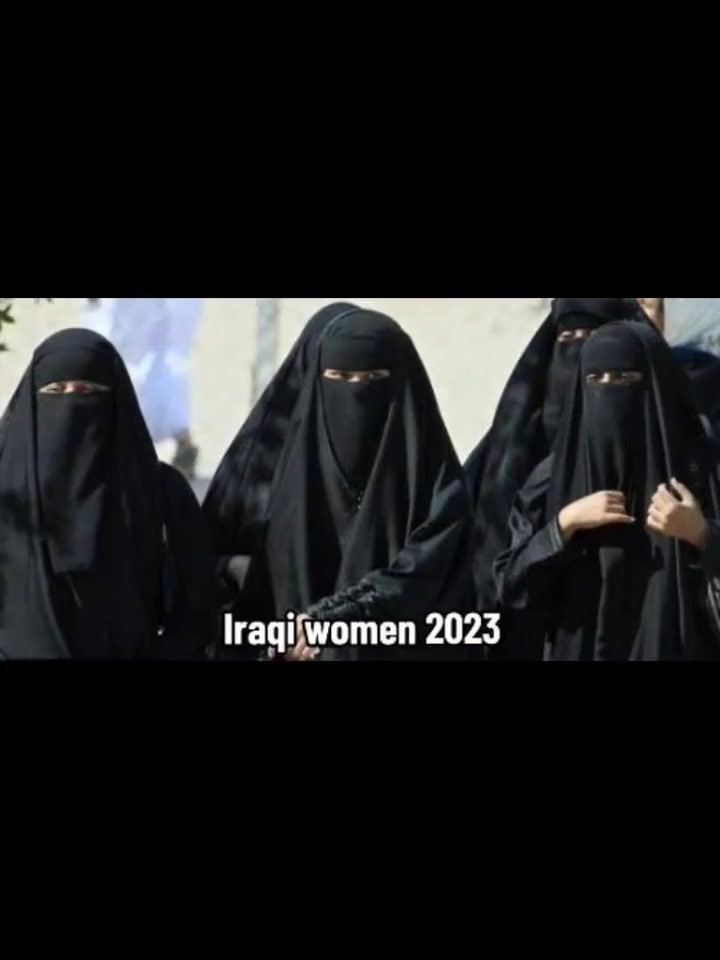 Iraqi women in 2023 in full black niqab, faces entirely covered, walking together.